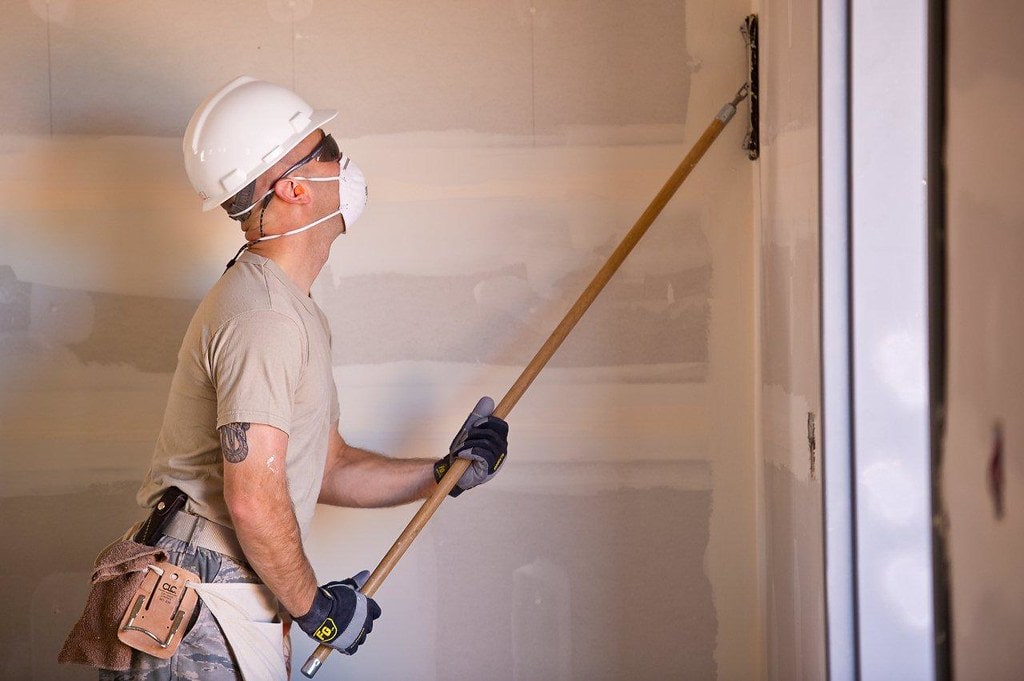 A worker using a drywall sander Drywall Sander